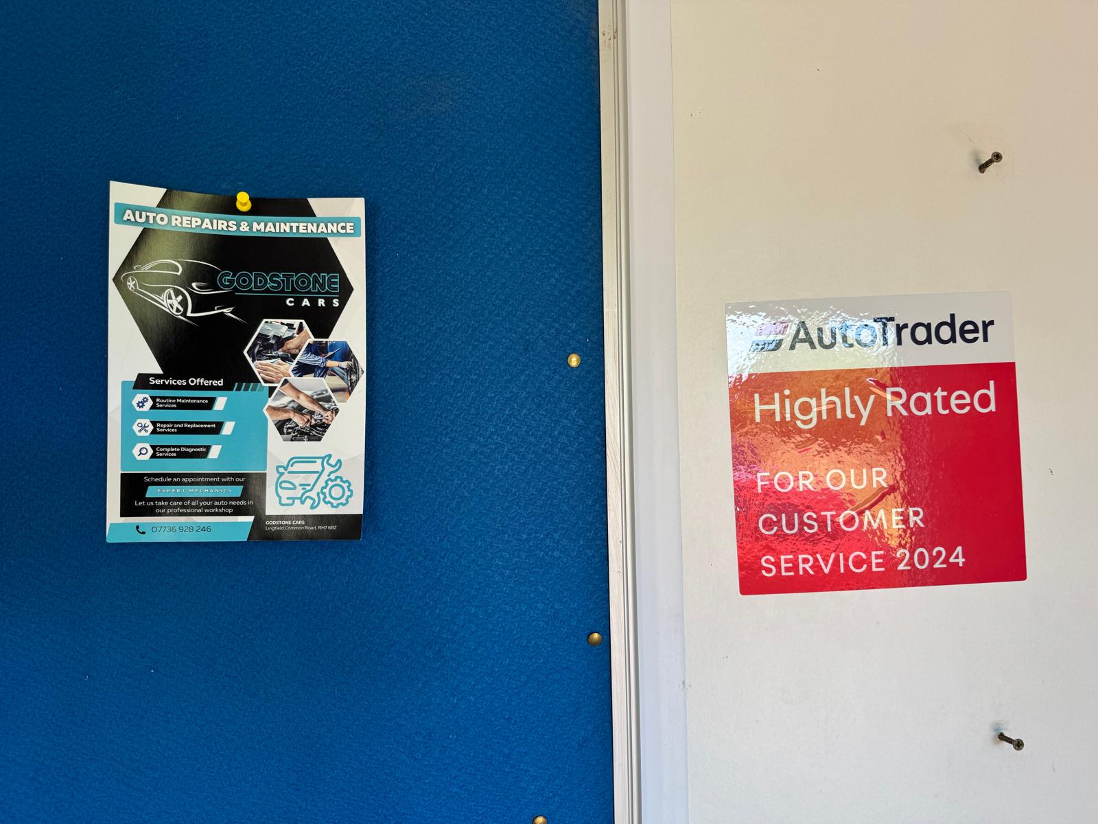 The Godstone Cars workshop flyer next to an AutoTrader Highly Rated 2024 sticker