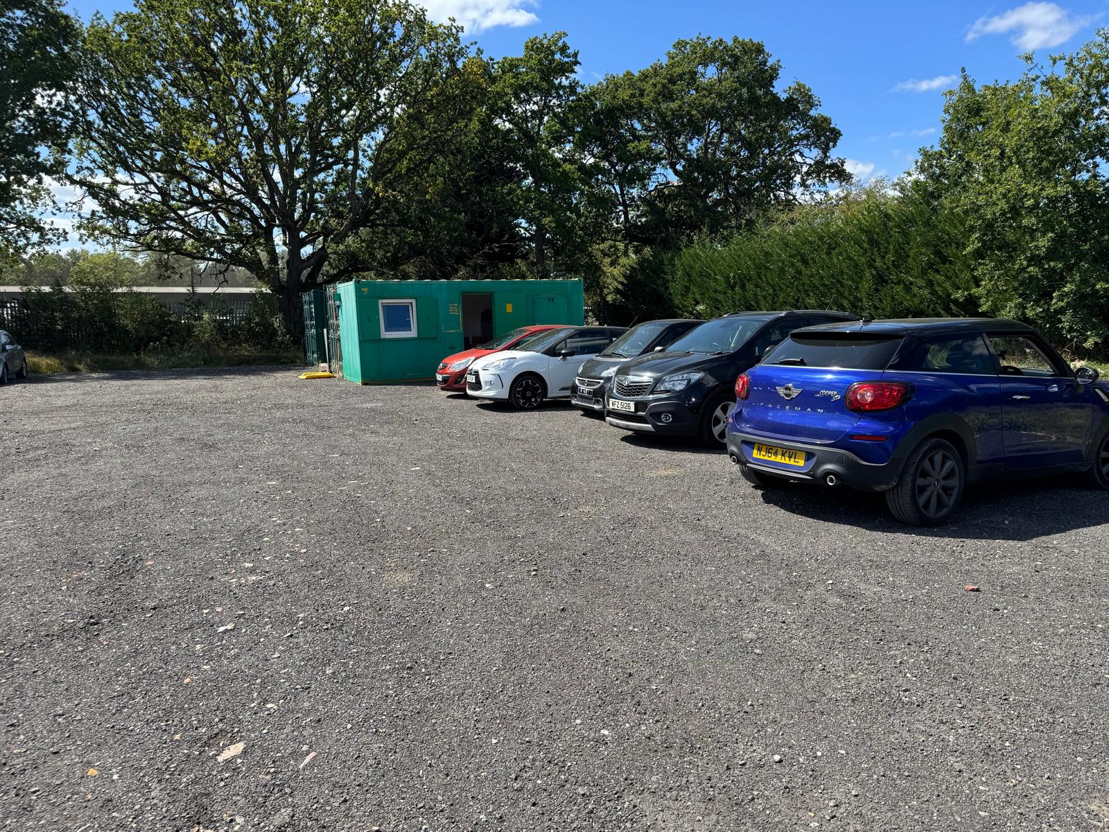 Used cars lined up on the Godstone Cars forecourt beside the site office